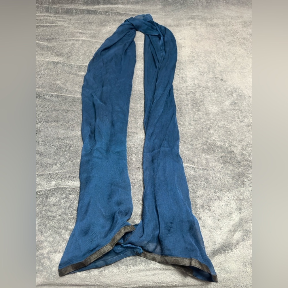 Woman’s long blue scarf